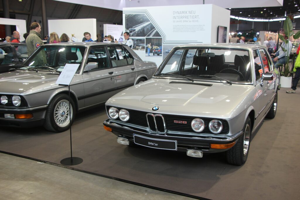 Silberner BMW 528 der Baureihe E12 von schräg vorn in einer Ausstellungshalle