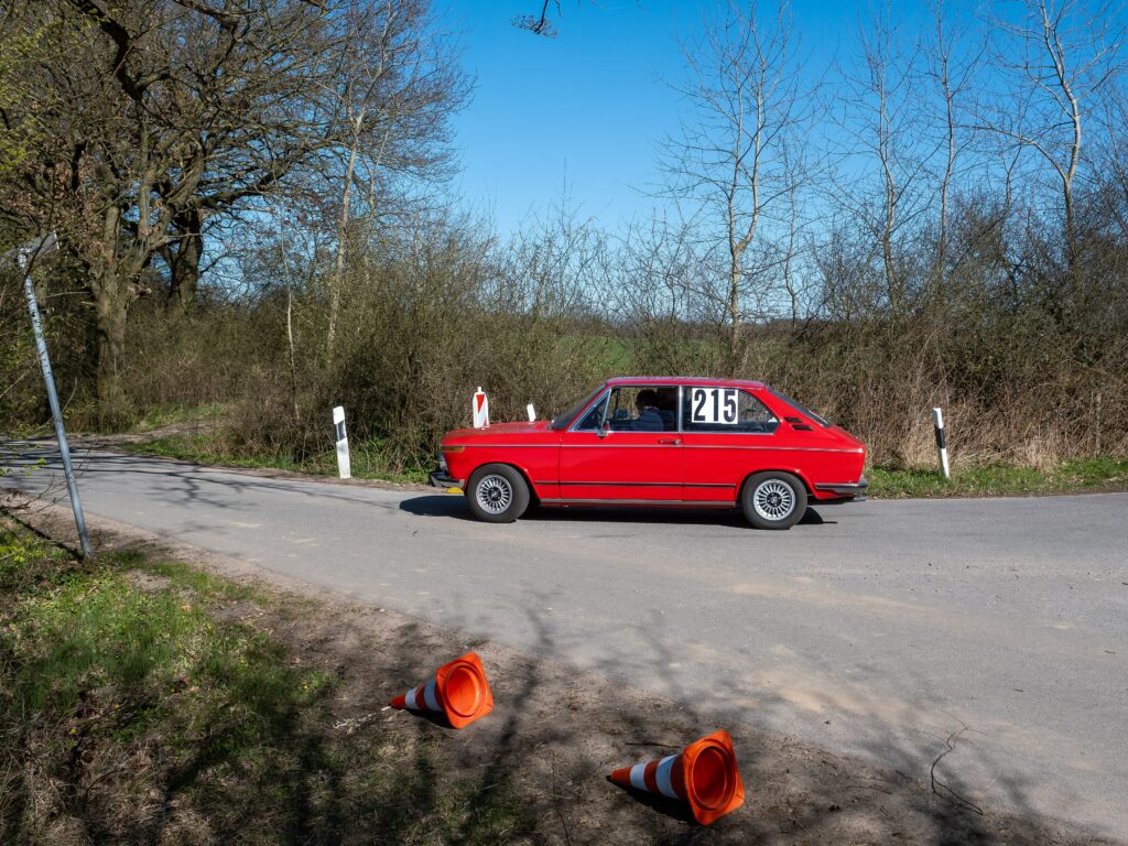 Roter BMW touring in Seitenansicht auf der Straße