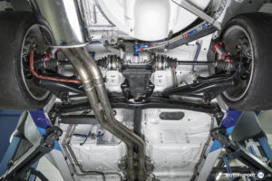 Untersicht eines BMW M3 E30 auf der Hebebühne mit Hinterachsdifferential, Antriebswellen und Schräglenkern