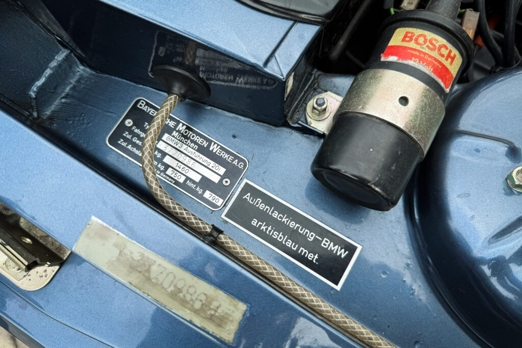 Typenschild eines BMW 320i der Baureihe E21 mit dem Hinweis Außenlackierung arktisblau met.